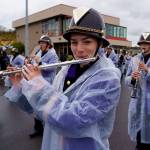 Oak Harbor High School senior Maggie Root tries to stay dry while marching and performing in the parade.