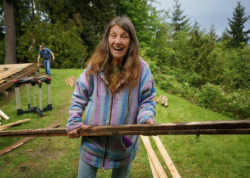 Photo by David Welton
A Hearts & Hammers volunteer pulls a rotten deck board on Saturday.