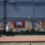 Paula Fries finishes her Serendipity Lane mural on Thursday. (Photo by Sam Fletcher)