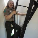 Interpretive specialist Jen Gray climbs up the ladder of the Admiralty Head Lighthouse. (Photo by Sam Fletcher)