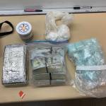 Oak Harbor police photo
plastic bags of suspected cocaine, a foil-covered brick of suspected cocaine, $79,000 in cash and large number blue "M30" pills.