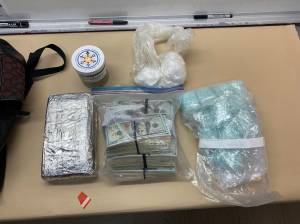 Oak Harbor police photo
plastic bags of suspected cocaine, a foil-covered brick of suspected cocaine, $79,000 in cash and large number blue "M30" pills.