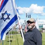 Ted Mansikka holds the Israel flag at a rally on Thursday. (Photo by Sam Fletcher)
