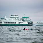 Two Washington State ferries pass along the route between Mukilteo and Clinton as scuba divers swim near the shore Sunday, Oct. 22, 2023, in Mukilteo, Washington. (Ryan Berry / The Herald)