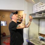Photo by Luisa Loi
Jason Youngsman tosses some fresh pizza dough into the air.