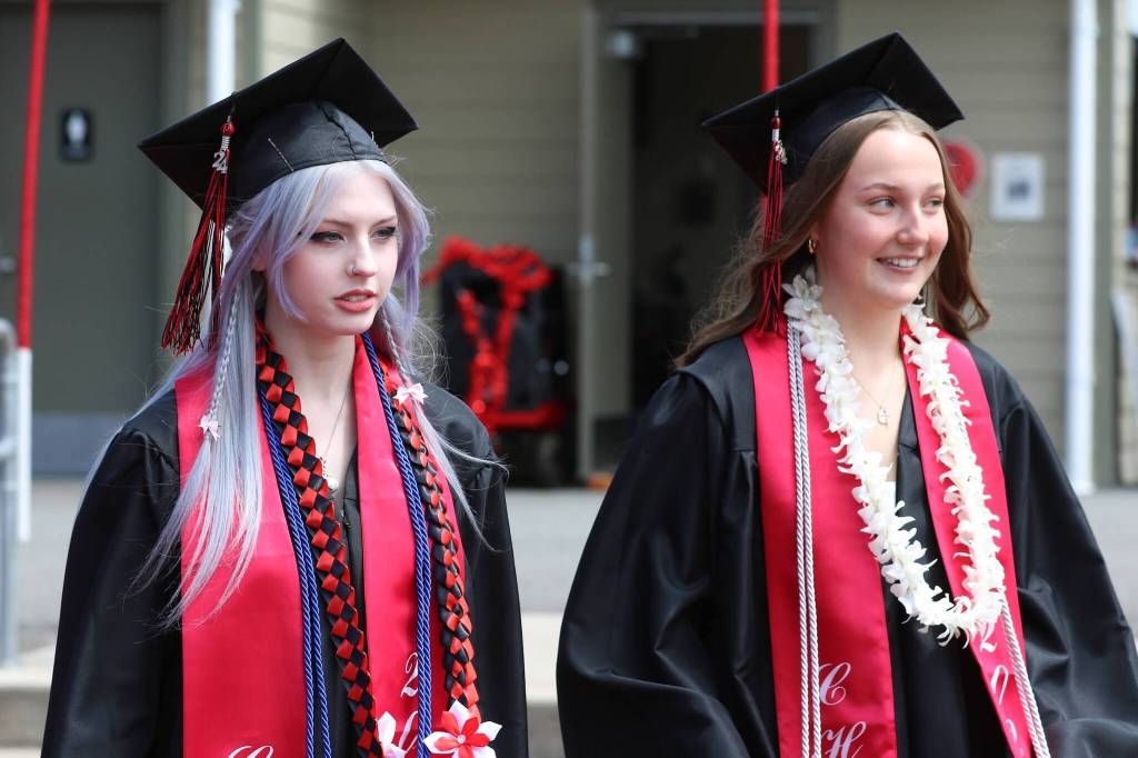 Bee Armstrong stands in graduation bliss with Kayla Arnold. (Photo by Bailey Thule)