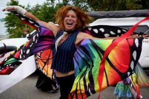 Photo by David Welton
A parade participant from Meander Dance Collective dances down the street at t
