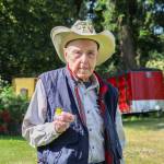 Mr. Hoolie holds a dandelion he plucked from his lawn. (Photo by Luisa Loi)