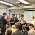 Police Chief Tony Slowik (right) provides a lifesaving award to Officer Jesse Caravan for his swift efforts during an overdose incident on May 10. (Photo provided)