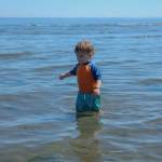 Toddler Kainoa Hagen-Ashe wades in the surf at Double Bluff Beach, July 9. (Photo by Caitlyn Anderson)
