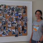 Photo by Caitlyn Anderson
Sarah Wheeler stands before a bulletin board full of pictures of her feline and canine clients.