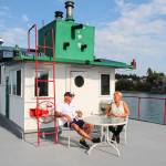 Kat and Dennis Redmon chat while enjoying the view of Penn Cove and music from a buskers performance on Front Street. (Photo by Luisa Loi)