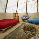 Shaded from the hot sun, the cool inside of the tipi contains beds, chairs and plenty of twinkle lights. (Photo by David Welton)