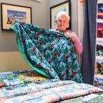 Mary Fyfe holds one of her Bigfoot-inspired blankets. (Photo by Luisa Loi)