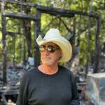 Photo by Heather Mayhugh
Gregg Fergel stands before the charred remains of his home in Clinton.