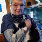 Freeland Cat Cottage manager Judy Dewing with Billy the Kid, a friendly tuxedo cat. (Photo by David Welton)