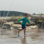 Tanner Marchant, 7, of Oak Harbor plays on the splash pad in Windjammer Park. (Photo by Caitlyn Anderson)