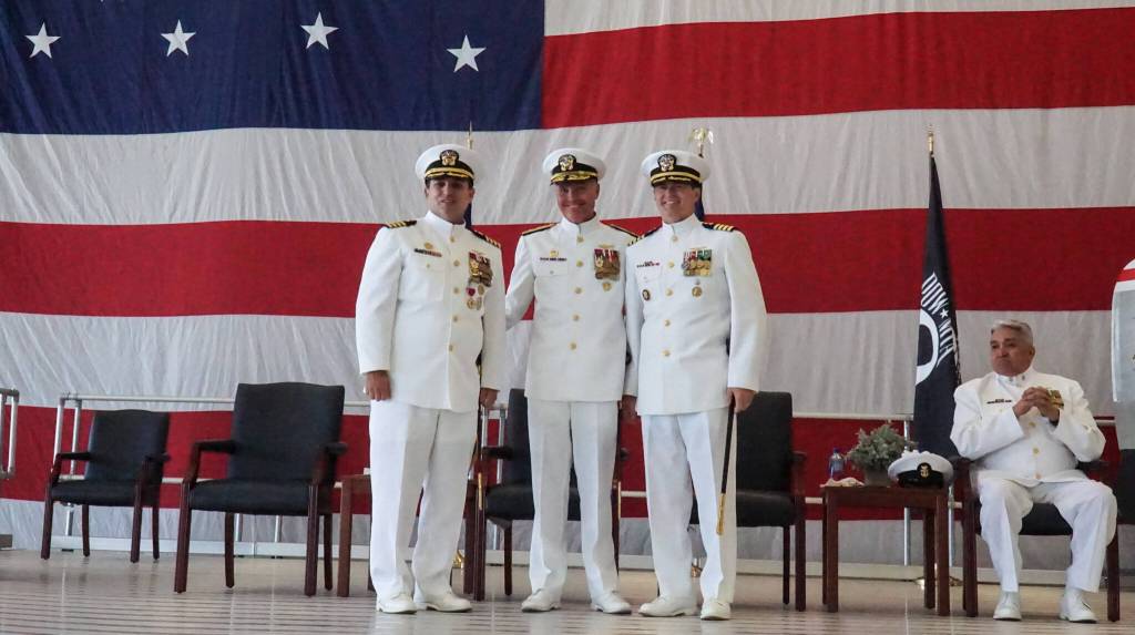 Photo by Sam Fletcher
Left to right, Commanding Officer Capt. Eric Hanks, Rear Admiral Mark Sucato and relieving Commanding Officer Capt. Nathan Gammache pose at the change of command ceremony on Thursday.