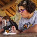 Pippa Place observes plankton she collected with a robot she built in the Atlantis STEAM robotics course. (Photo by Sam Fletcher)