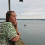 Photo by Luisa Loi
Death Doula Amy Briscoe pensively admires the waters of Penn Cove from the Coupeville Wharf.