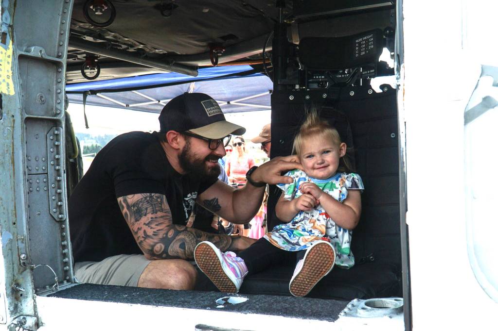 Photo by Sam Fletcher
Connor Kusick plays with his daughter, Kaylee, in the Search and Rescue helicopter at Naval Air Station Whidbey Island on Saturday.