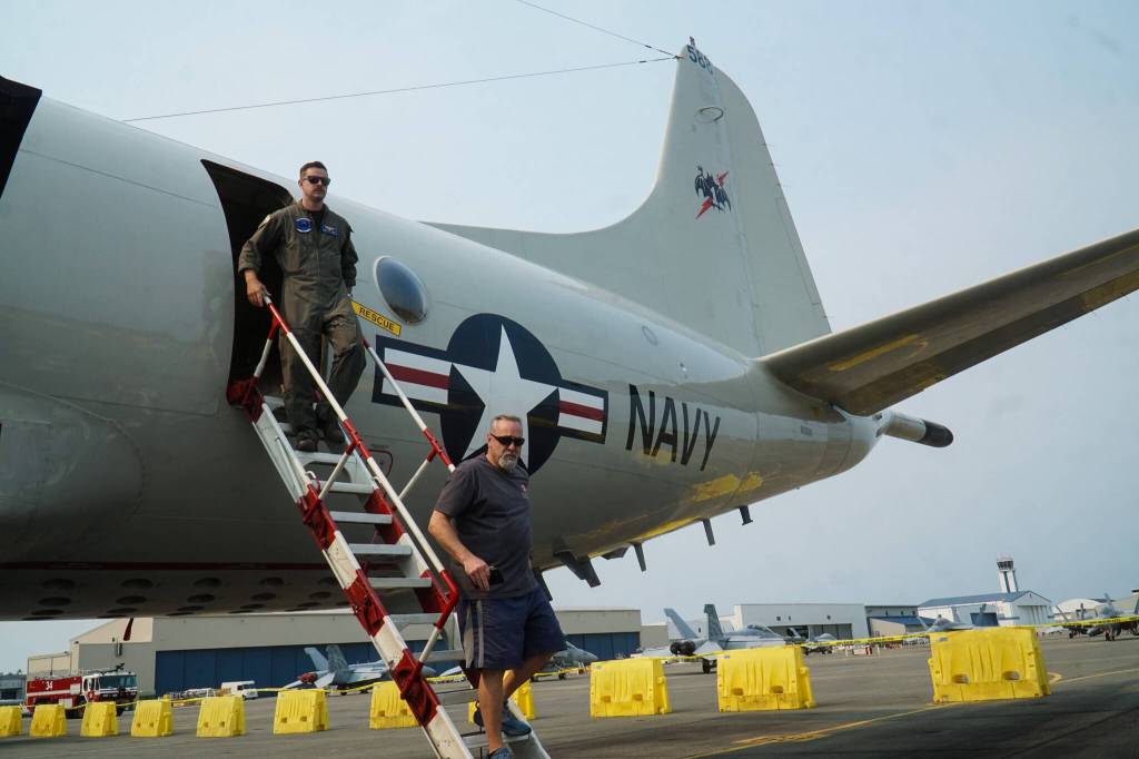 Photo by Sam Fletcher
Lt. Justin Goode and Dan Gleeson exit the P-3 Orion at Naval Air Station Whidbey Island on Saturday.