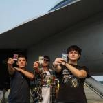 Left to right: Ty Johnon, Aiden Pieste and Cash Crites display Yu-Gi-Oh cards before a growler at Naval Air Station Whidbey Island on Saturday. (Photo by Sam Fletcher)