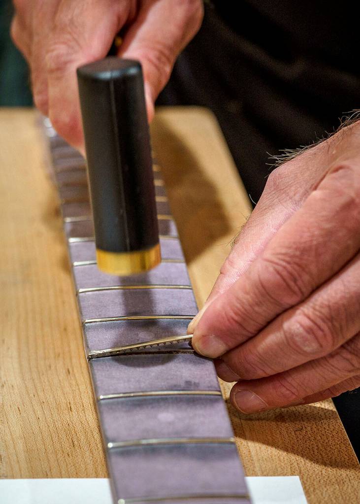 Darrell Pope demonstrates how to put a new fret in. (Photo by David Welton)