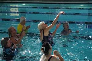 Carol Parbs hits the volleyball at the John Vanderzicht Memorial Pool Monday morning. (Photo by Sam Fletcher)