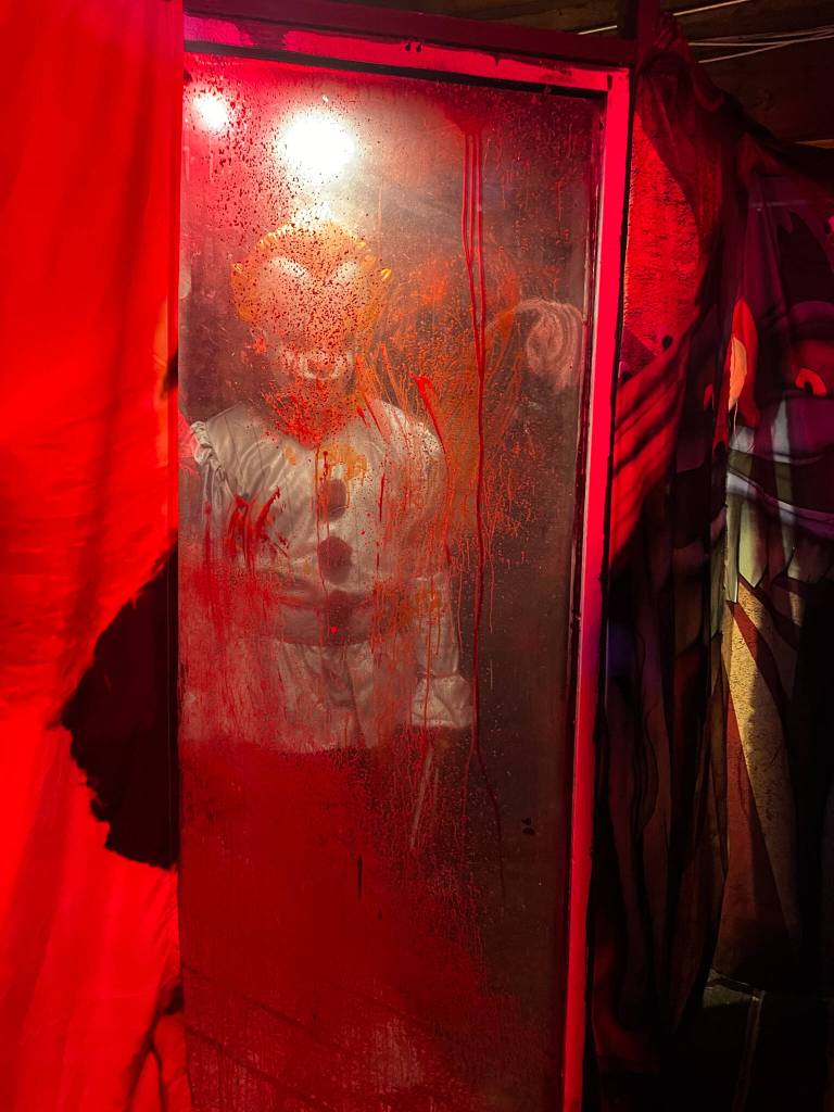 Pennywise lurks behind glass at Return of Frightville in Oak Harbor. (Photo by Cackles the Clown)