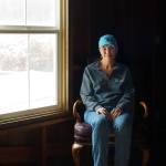 (Photo by David Welton)
Hollie Swanson sits in an antique chair next to the window where an unexplainable shadow was captured on video by ghost hunters last Halloween.