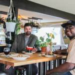 Co-Owners Sedrick Livingston, at right, and Tyler Hansen enjoy a meal at Goldie's and The Roost, a restaurant they opened with Sophia Jones.