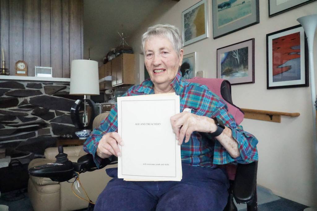 Barb Bland, founder of Whidbey Writers Group, holds the groups first anthology, released in 1990. (Photo by Sam Fletcher)
