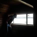 Reese Bliek, owner of Coppertop Construction, looks out the loft window of a Pioneer Way home built in 1925. (Photo by Sam Fletcher)