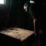 Reese Bliek, owner of Coppertop Construction, reads a newspaper dated 1983 in the basement of a Pioneer Way home built in 1925. (Photo by Sam Fletcher)