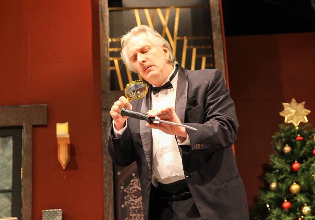 William Gillette (Ben Honeycutt) inspects a knife found on the crime scene. (Photo by Luisa Loi)
