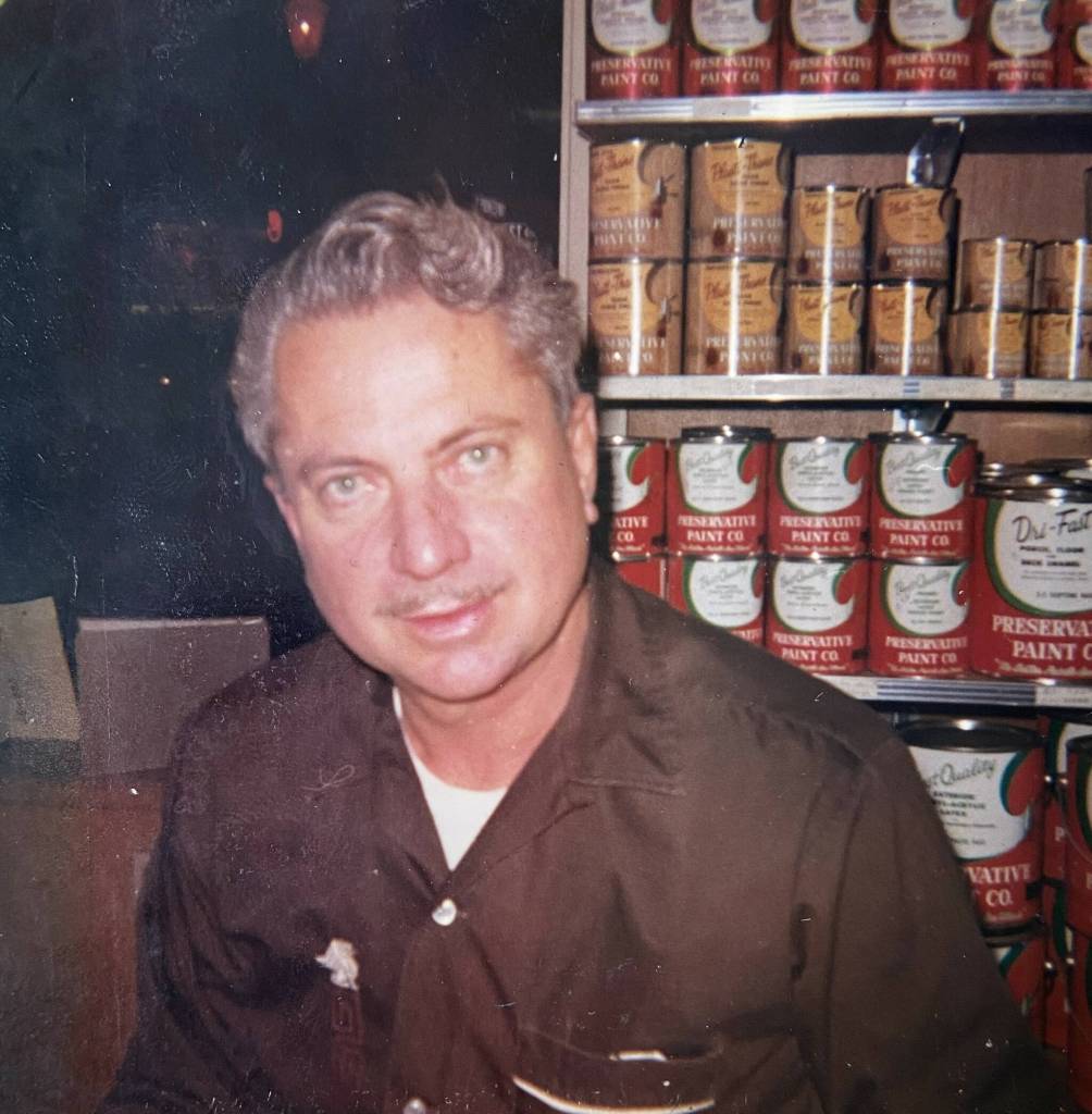 A younger Gene works at the paint store in the 1960s, before he started selling fine art supplies. (Photo provided)