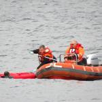 Photo provided
Washington State Ferries crew members help a kayaker in distress climb aboard their rescue vessel Sunday.