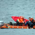 Photo provided
Washington State Ferries crew members help a kayaker in distress climb aboard their rescue vessel Sunday.