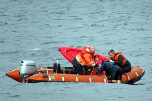 Photo provided
Washington State Ferries crew members help a kayaker in distress climb aboard their rescue vessel Sunday.