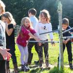 At left, Michael Burrier, Aria Sarver, Olivia Imbery, Neve Hoelting and Finn Schierholtz wash their hands before eating some garden tacos, made with the fruits of their labor. (Photo by Luisa Loi)