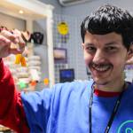 (Photo by Luisa Loi)
Roman holds corn-shaped earrings.
