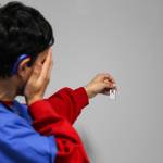 (Photo by Luisa Loi)
Roman measures his visual acuity with a Snellen eye chart earring.
