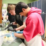 (Photo by Luisa Loi)
Devon Grau, in the foreground, cuts onions with fellow student Raiden Milliron.