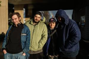 Nick Coloso (left), Phoenix Welch (middle-right) and other patrons of the SPIN Cafe await meals on Friday. (Photo by Sam Fletcher)