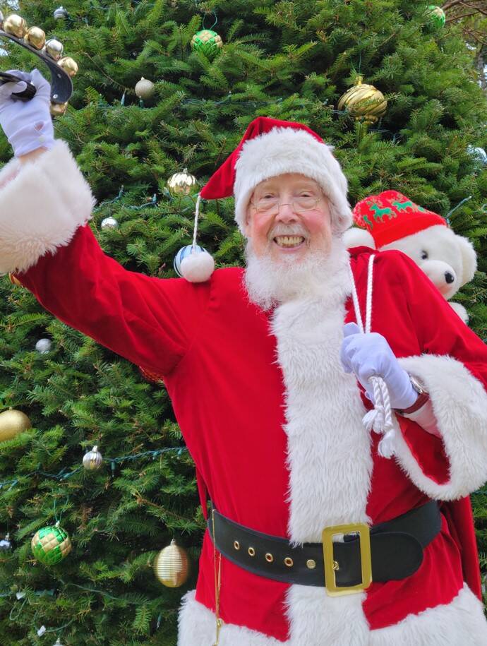 (Photo provided)
Santa Claus, also known as David Paull, waves cheerfully at the camera while shaking his reindeer bells.