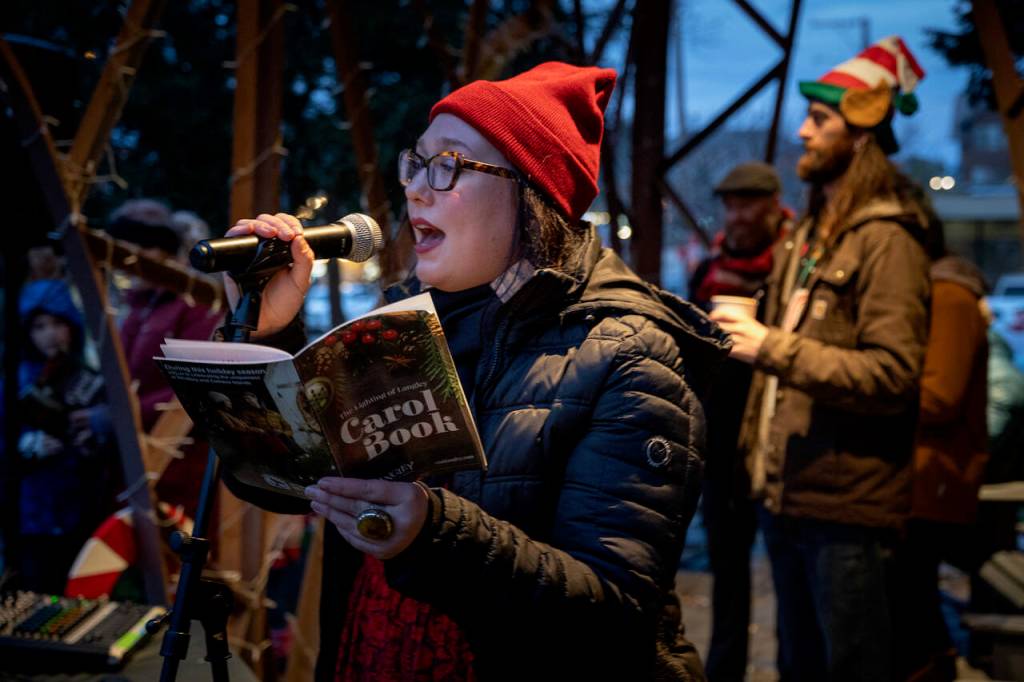 (Photo by David Welton)
Joanna Cary leads the carols.