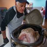 (Photo by David Welton)
Mike Dietrich checks to see if a turkey is ready.