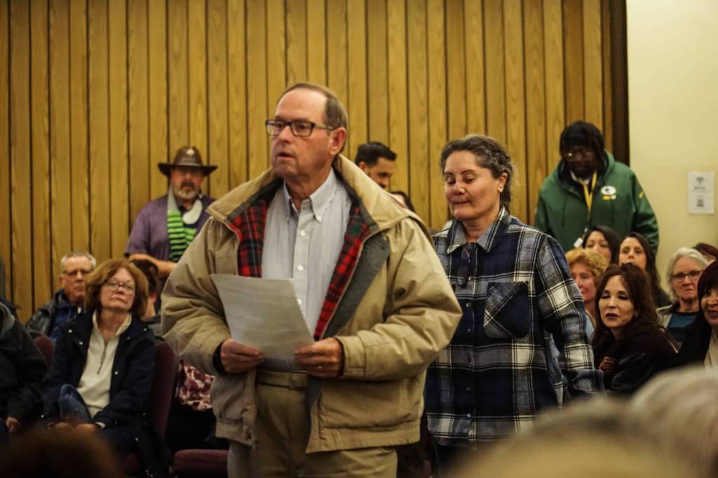 John Solin, owner of Oak Harbor Cinemas next door to the SPiN Cafe, waits in line to comment on the nonprofits effect on local businesses. (Photo by Sam Fletcher)