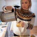(Photo by David Welton)
Lindsay Kelley pours hot wax, infused with the scent of Pear Prosecco, into candle molds.
